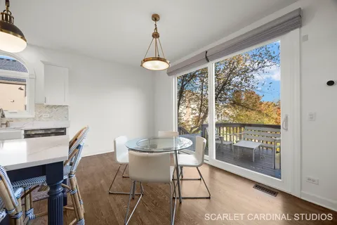 a dining room with furniture a chandelier and wooden floor