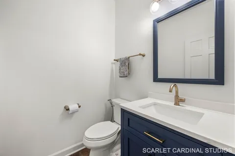 a bathroom with a sink toilet and mirror