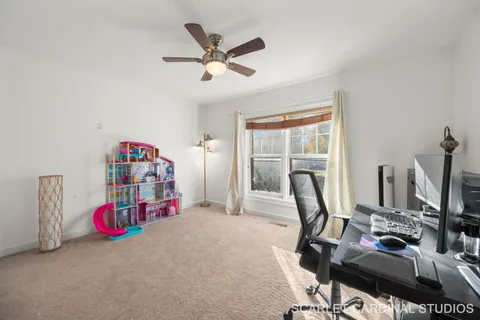 a view of a workspace with furniture and a flat screen tv