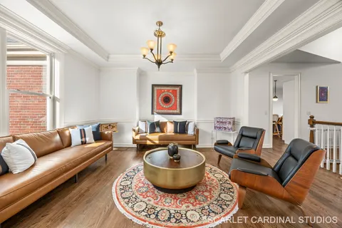 a living room with furniture a rug and a window