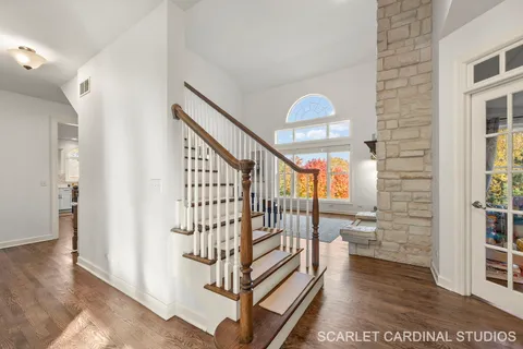 a view of entryway with wooden floor and windows