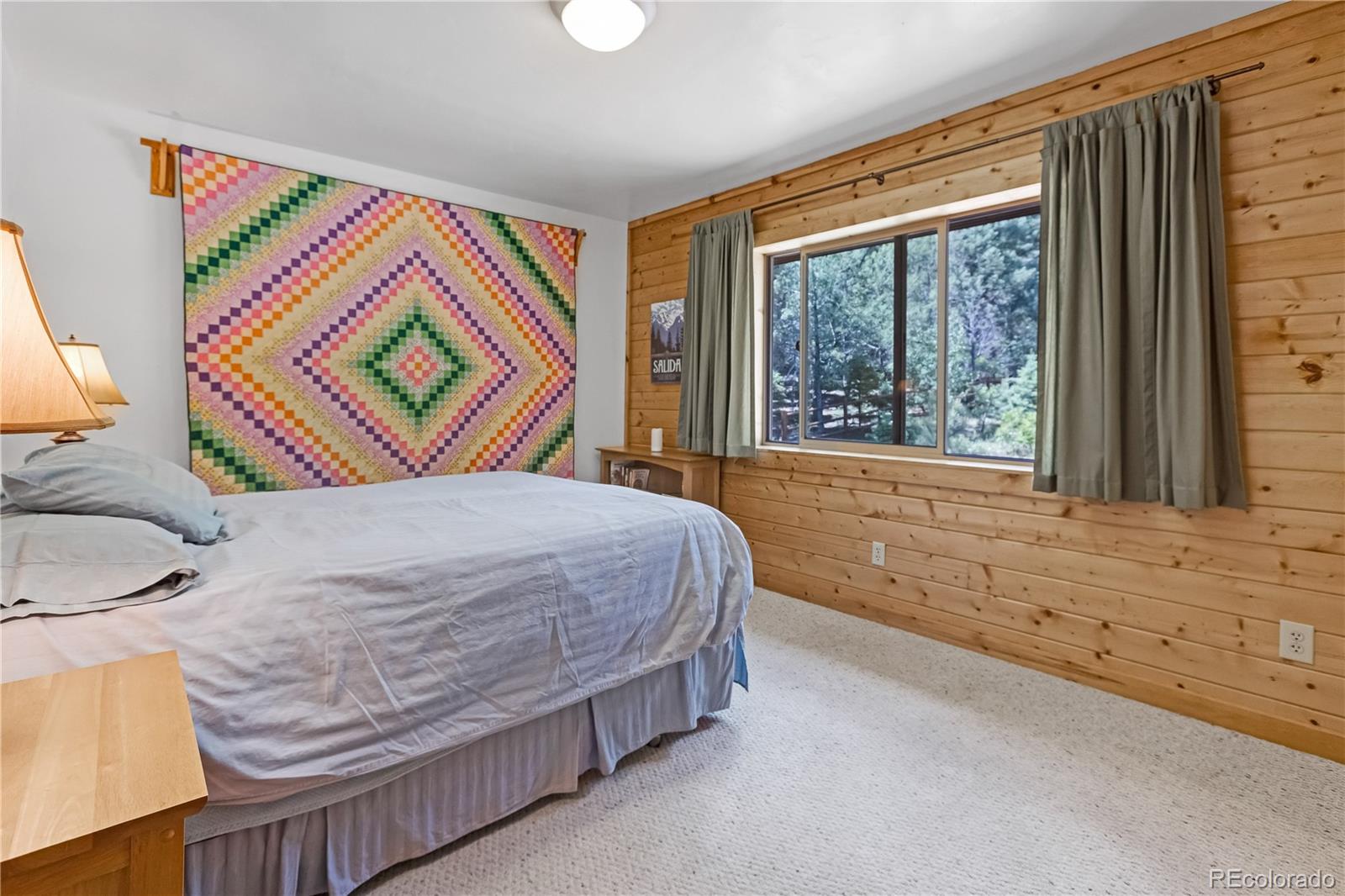 83 Forest Lane Howard, CO 81233 - Photo 14 of 43 a bedroom with a bed and a large window