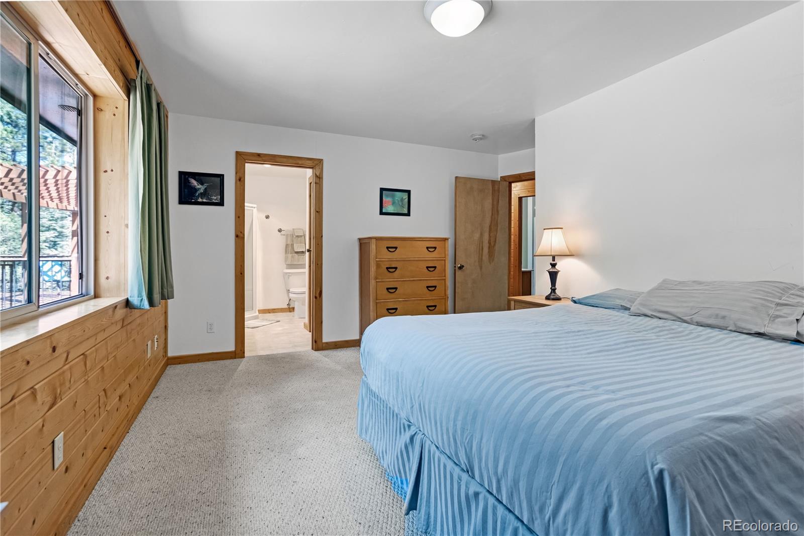 83 Forest Lane Howard, CO 81233 - Photo 15 of 43 a bedroom with a bed and dresser with windows