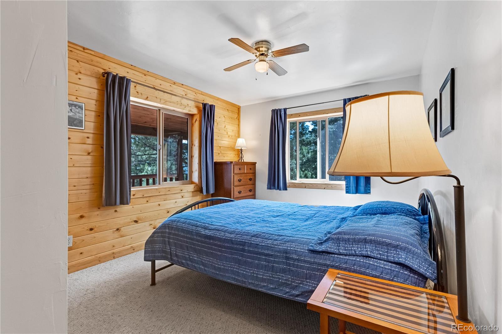 83 Forest Lane Howard, CO 81233 - Photo 18 of 43 a bedroom with a bed lamp and a large window with outer view