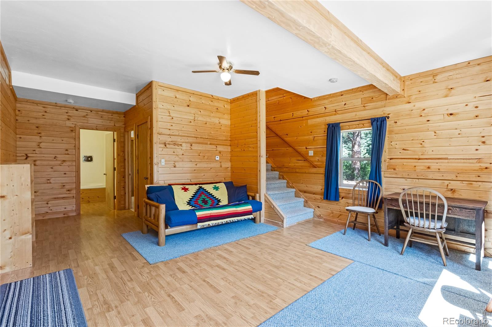83 Forest Lane Howard, CO 81233 - Photo 22 of 43 a living room with furniture gym equipment and wooden floor