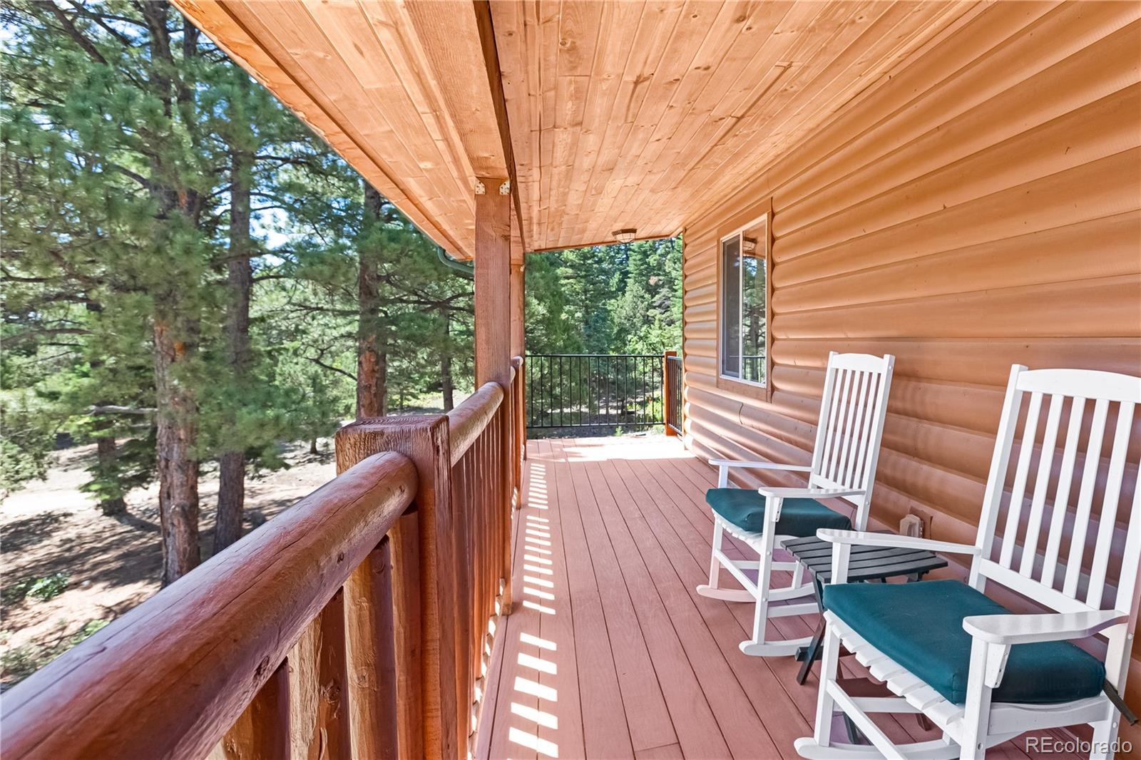 83 Forest Lane Howard, CO 81233 - Photo 3 of 43 a view of balcony with wooden floor and outdoor seating