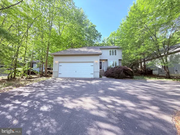 a view of a house with a yard and garage