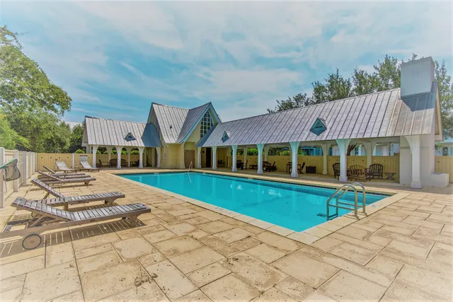a view of house with garden space and swimming pool