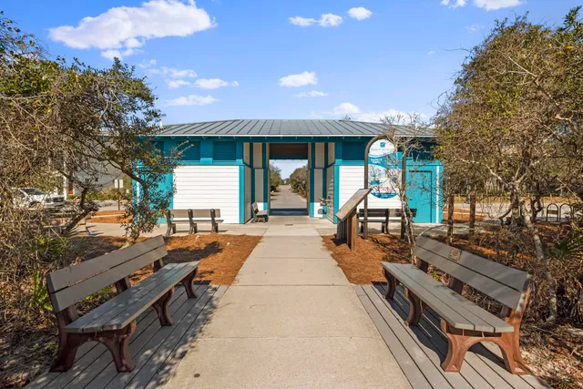 a view of a patio with dining table and chairs with wooden floor and fence