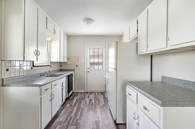 a kitchen with a sink stove and cabinets
