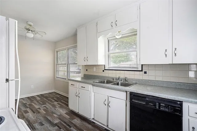 a kitchen with a sink stove and cabinets