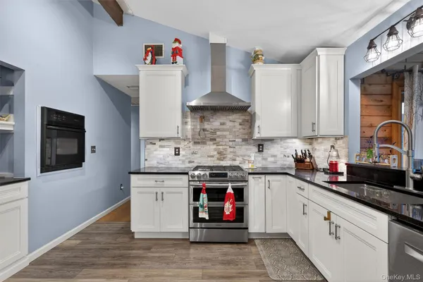 a kitchen with a refrigerator and a stove
