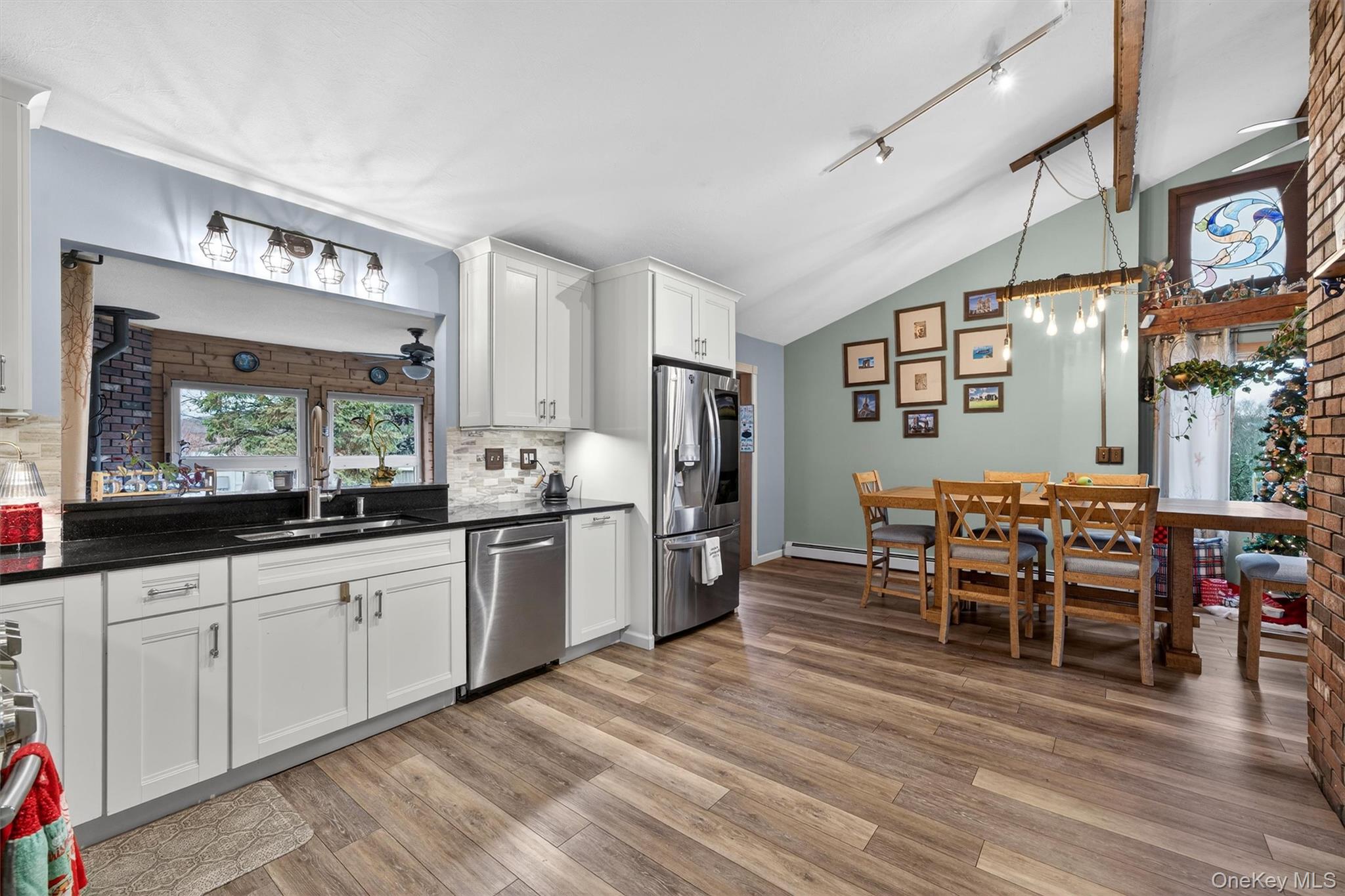 65 Bailey Road New Hampton, NY 10958 - Photo 16 of 50 Kitchen featuring white cabinets, stainless steel appliances, dark stone countertops, decorative light fixtures, and lofted ceiling