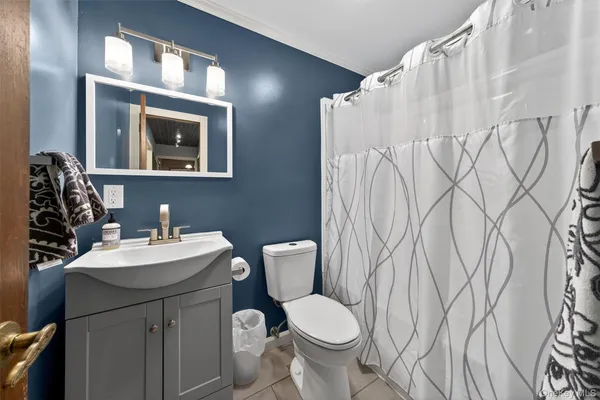a bathroom with a glass shower door