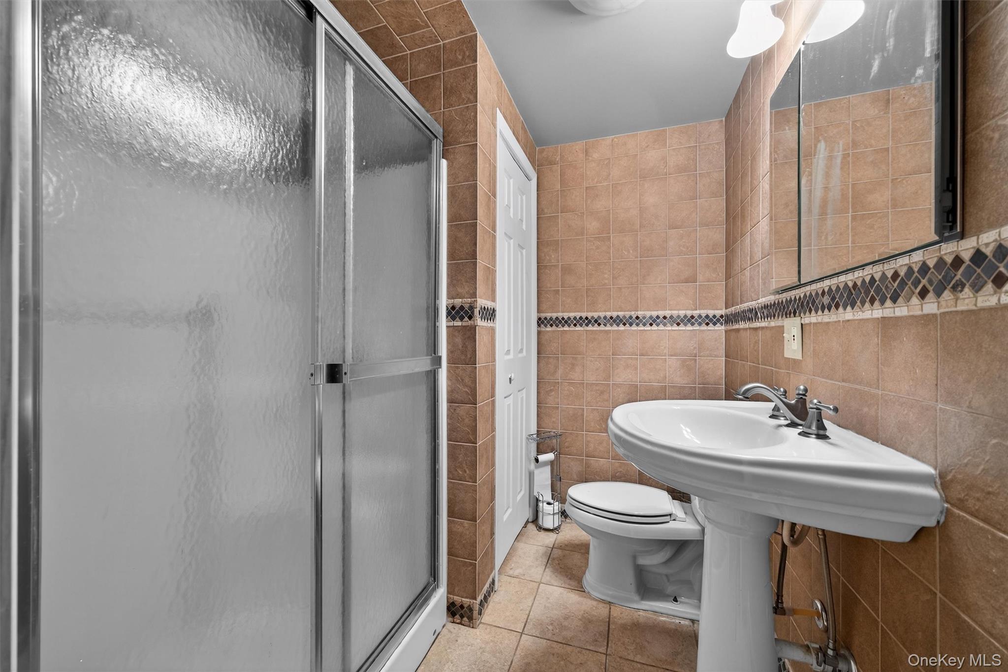 65 Bailey Road New Hampton, NY 10958 - Photo 42 of 50 a bathroom with a sink a toilet and shower