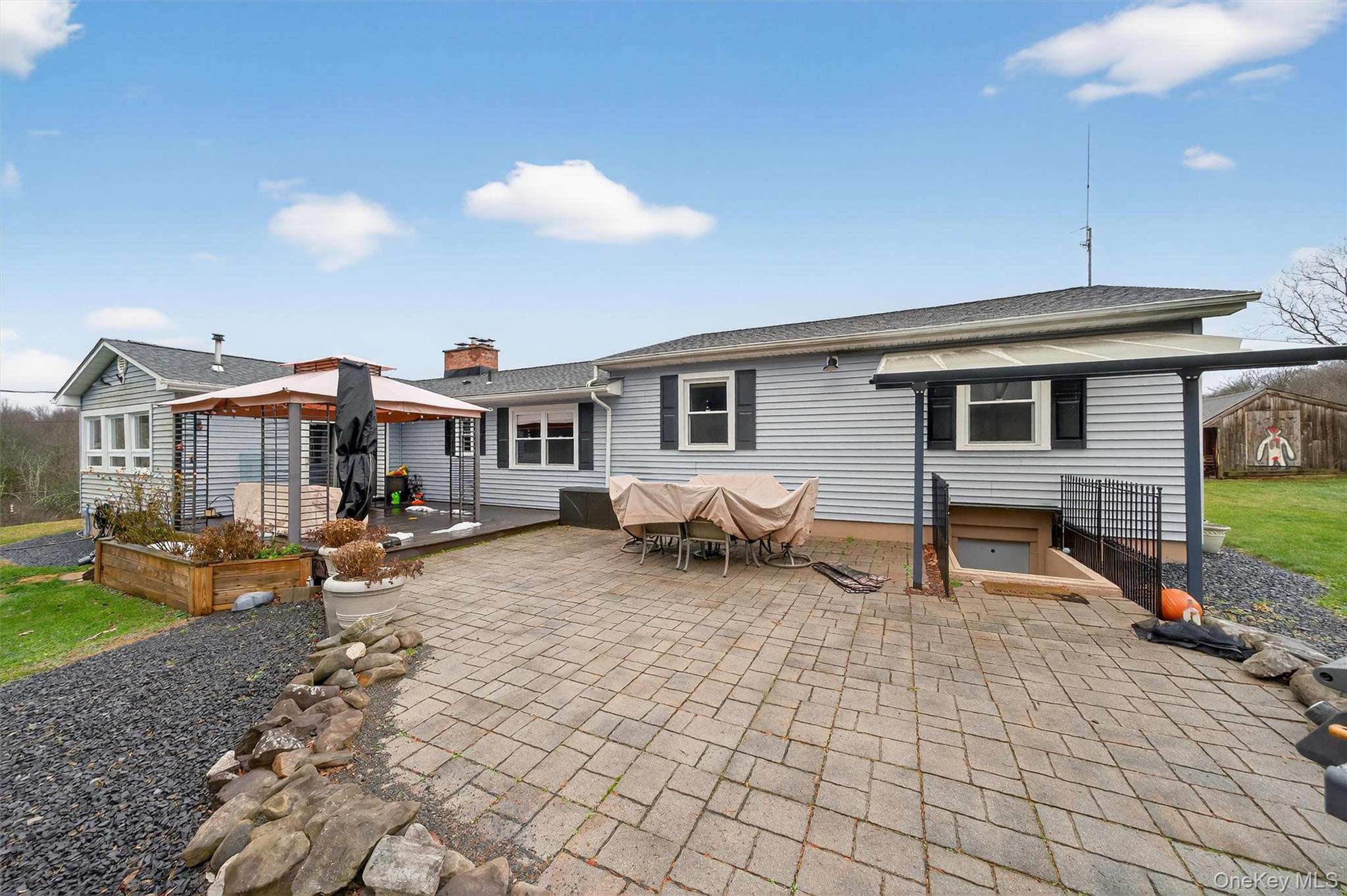 65 Bailey Road New Hampton, NY 10958 - Photo 44 of 50 a backyard of a house with barbeque oven table and chairs