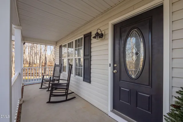 a view of front door with porch and furniture