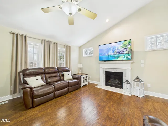 a view of backyard with table and chairs and a large tree