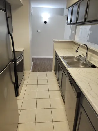 a kitchen with a sink a counter top space and appliances