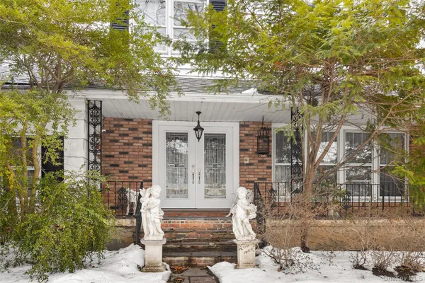 front view of a house with a tree