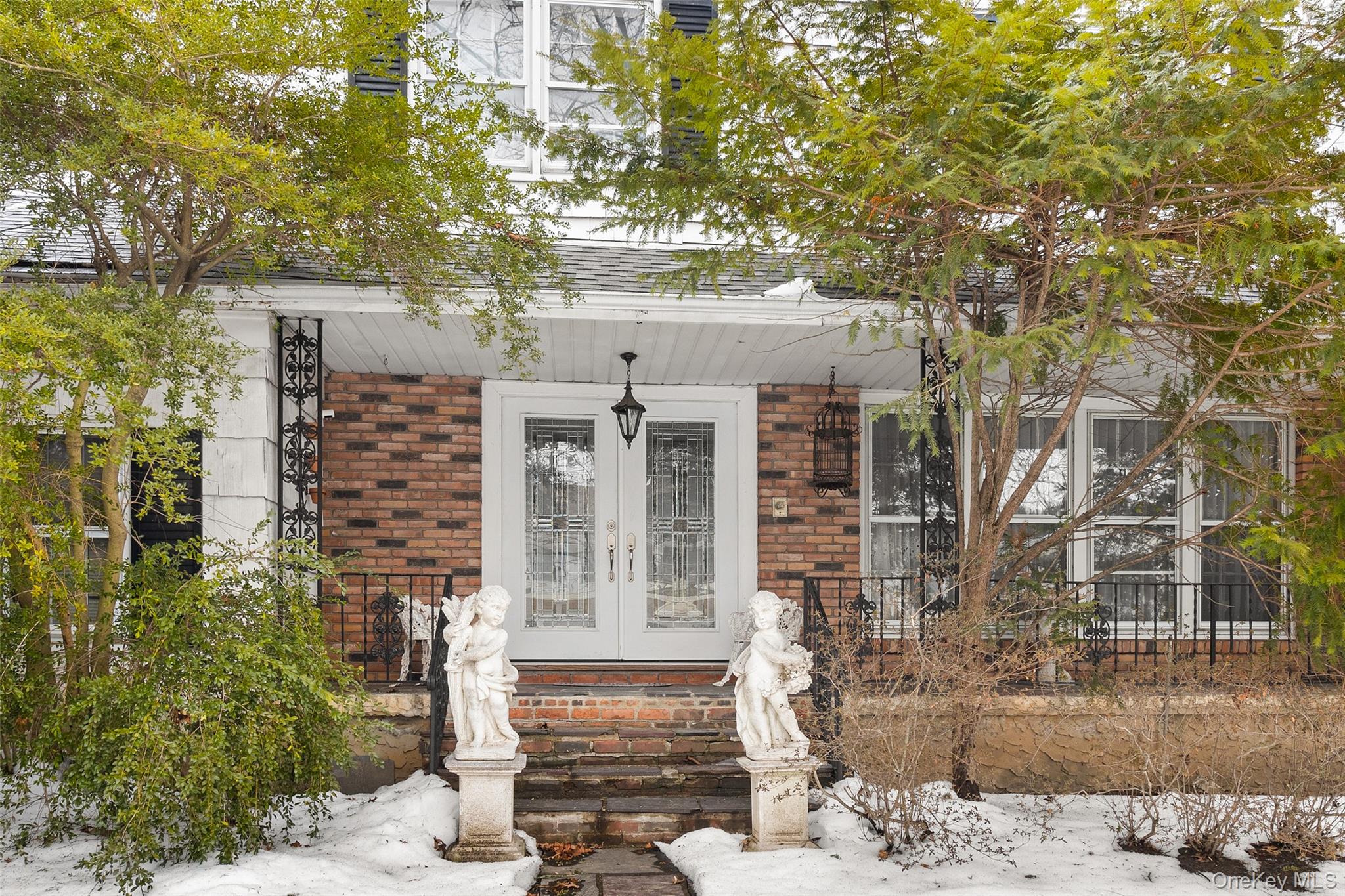front view of a house with a tree