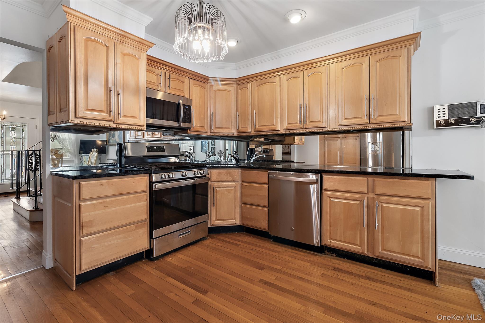 20 Old Farm Road Scarsdale, NY 10583 - Photo 12 of 40 a kitchen with stainless steel appliances granite countertop a stove a sink dishwasher and a microwave oven with cabinets