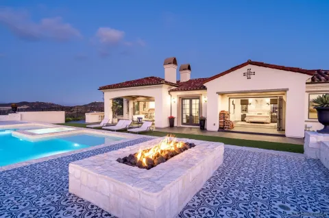 a view of a house with swimming pool and sitting area