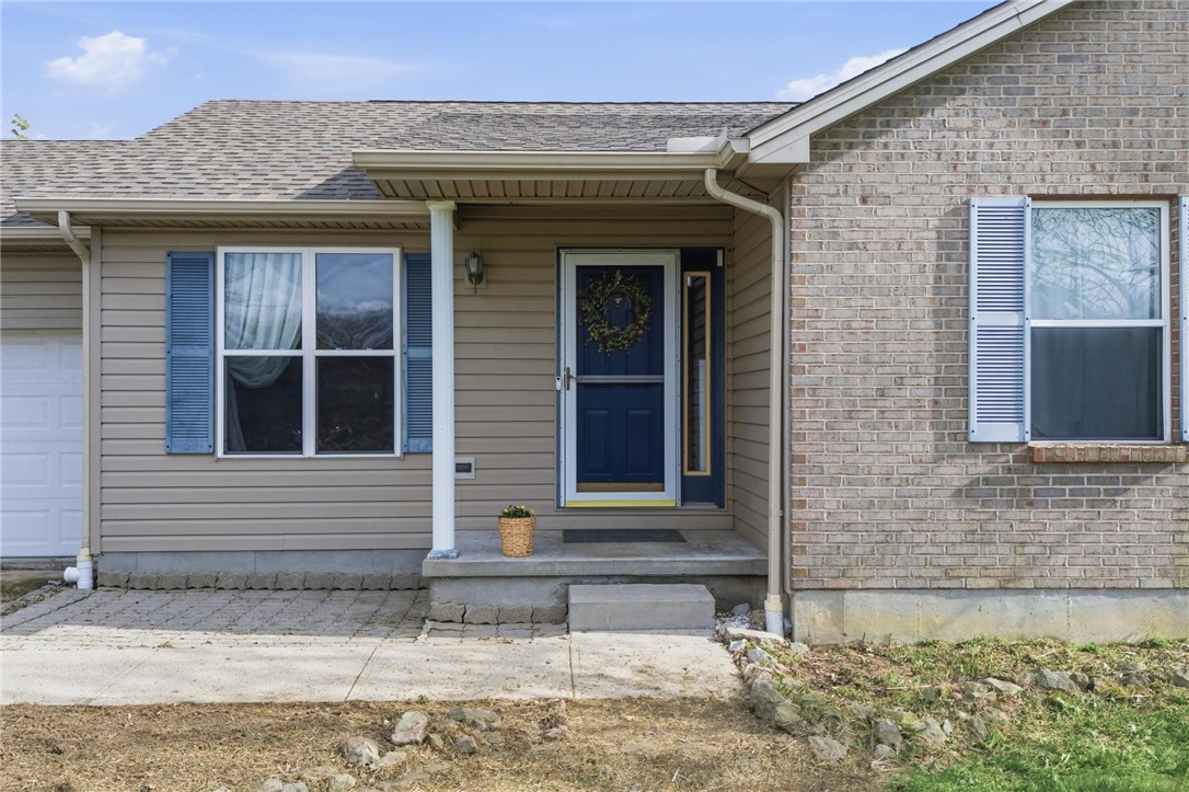 8747 Waynes Way Blanchester, OH 45107 - Photo 2 of 40 This inviting home presents a blend of brick and siding, complemented by charming blue window shutters.