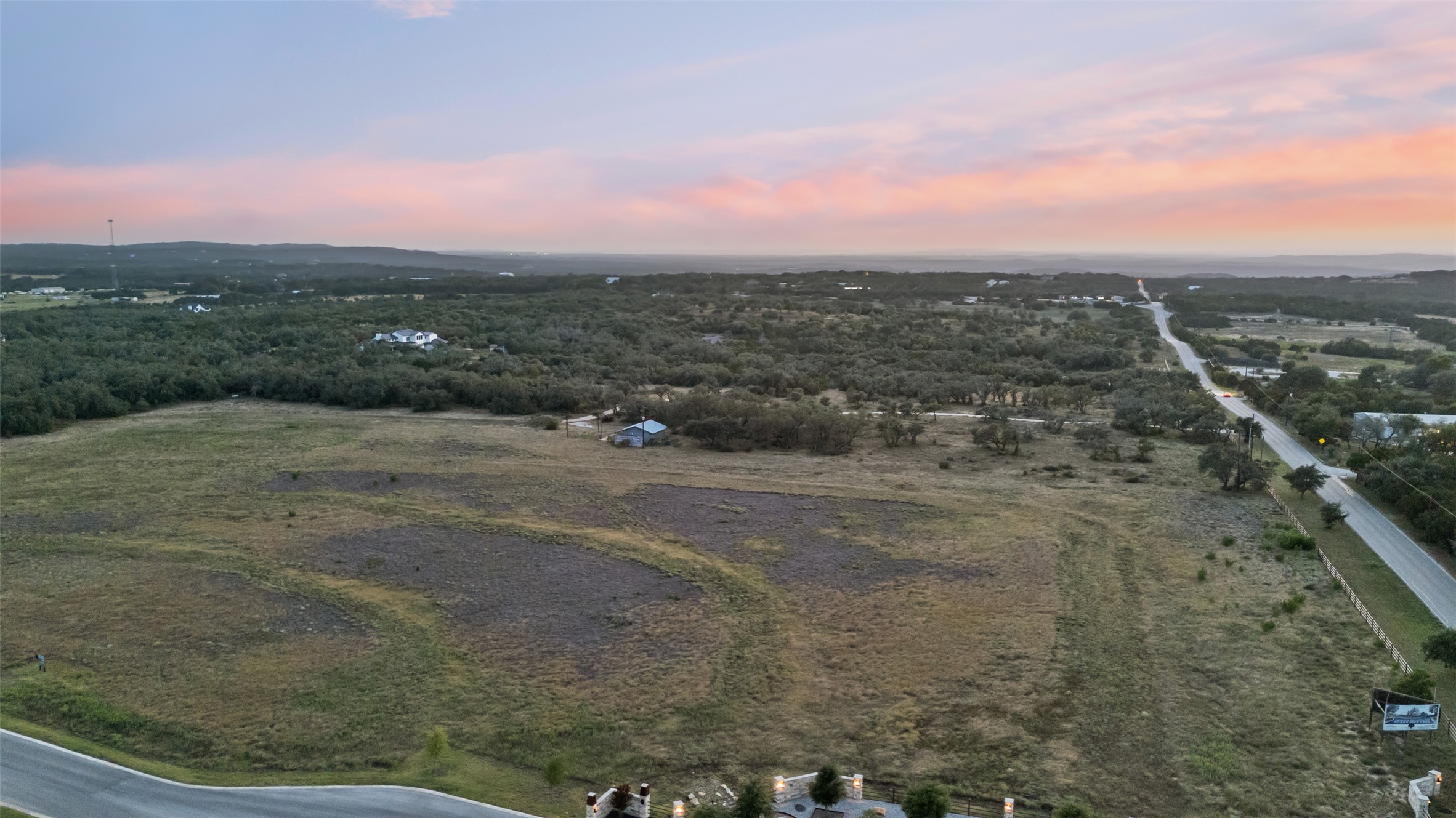Lot 3 West Fitzhugh Road Dripping Springs, TX 78620 - Photo 7 of 9 An aerial perspective showcases vast open acreage bordered by mature trees and countryside roads.