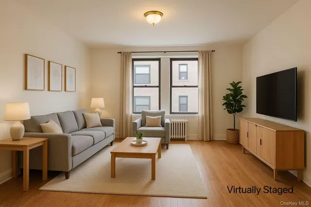 a living room with furniture a flat screen tv and a window