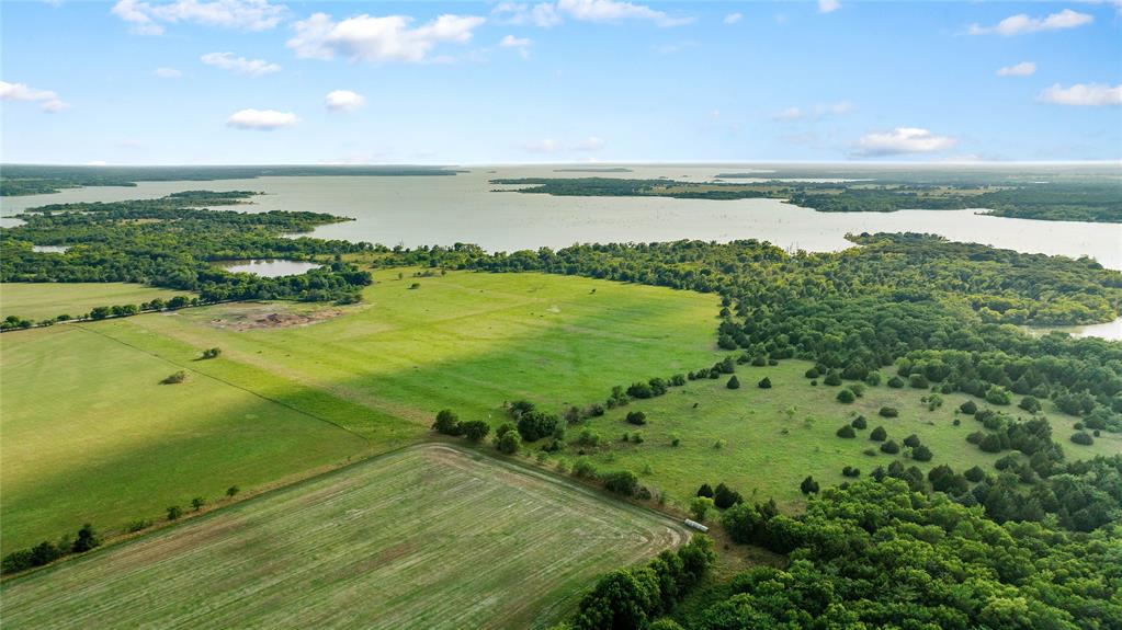 0 West Hinton Street Tioga, TX 76271 - Photo 7 of 8 a view of a lake from a yard