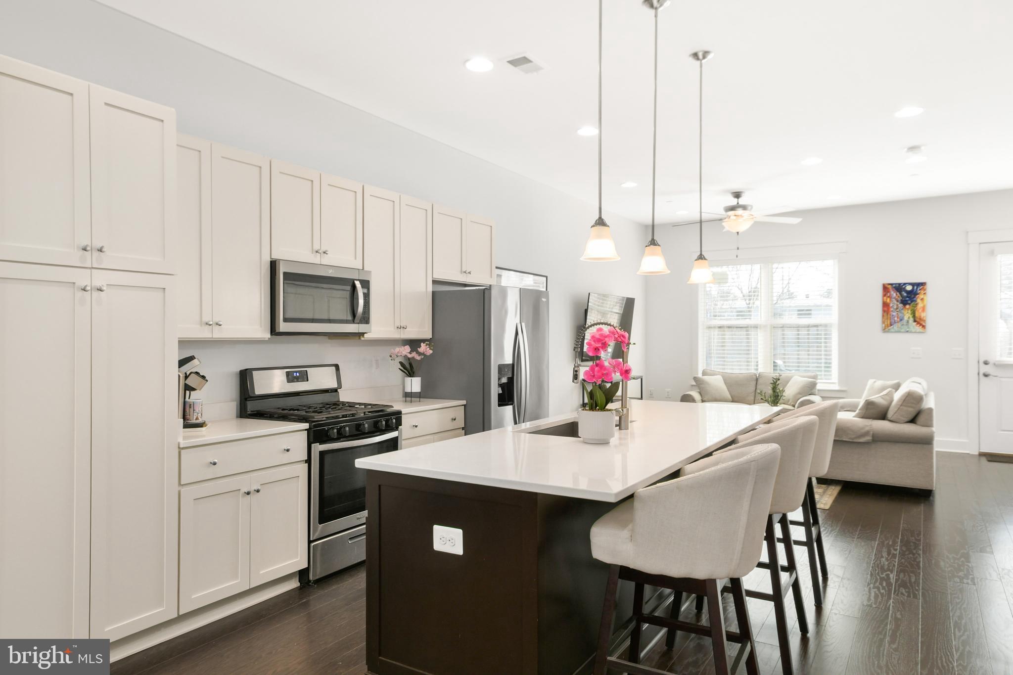 224 East 6th Street Frederick, MD 21701 - Photo 15 of 55 a kitchen with stainless steel appliances kitchen island granite countertop a sink a stove and a refrigerator