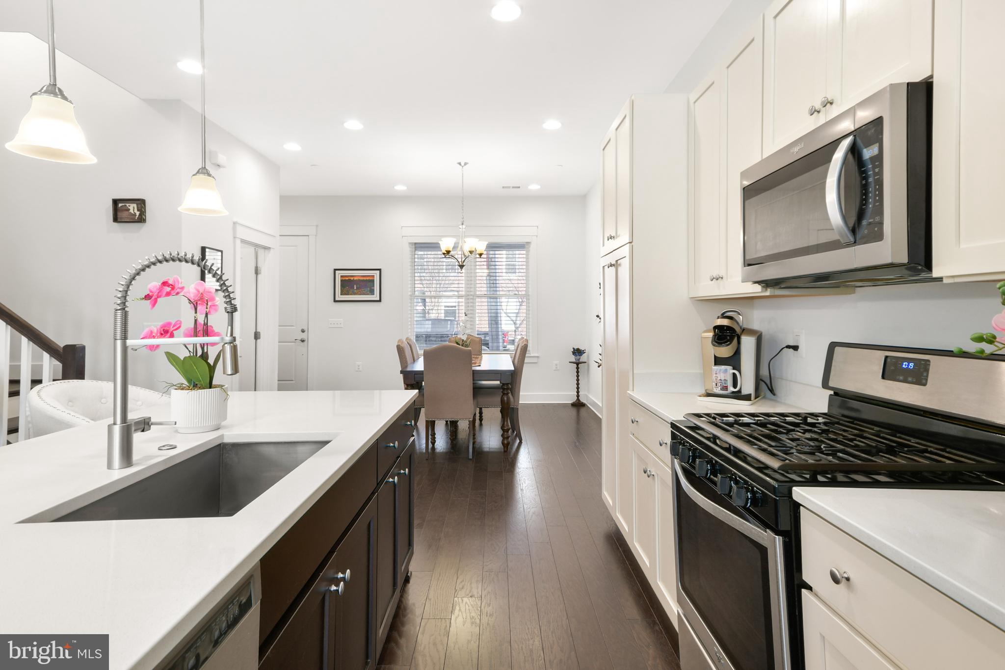 224 East 6th Street Frederick, MD 21701 - Photo 20 of 55 a kitchen with stainless steel appliances kitchen island granite countertop a stove a sink and a microwave