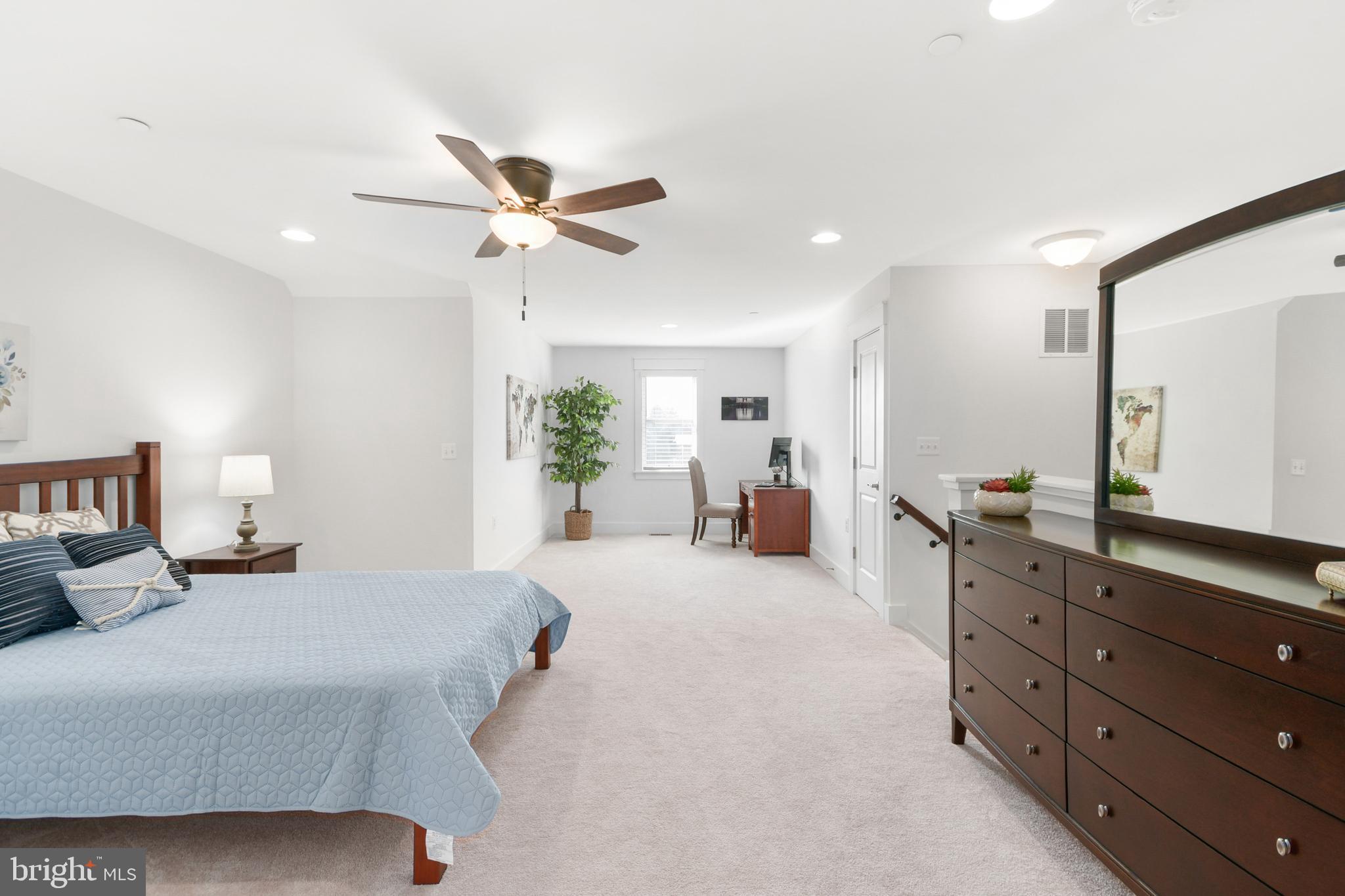 224 East 6th Street Frederick, MD 21701 - Photo 45 of 55 a bedroom with a bed a chandelier and dresser