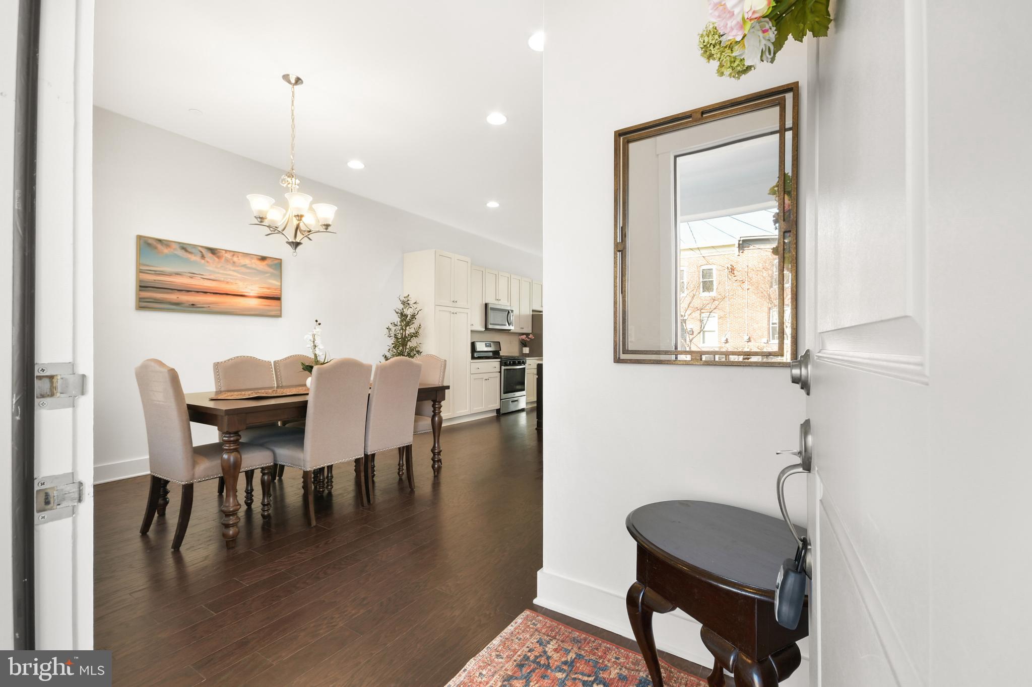 224 East 6th Street Frederick, MD 21701 - Photo 7 of 55 a dining room with wooden floor and a chandelier