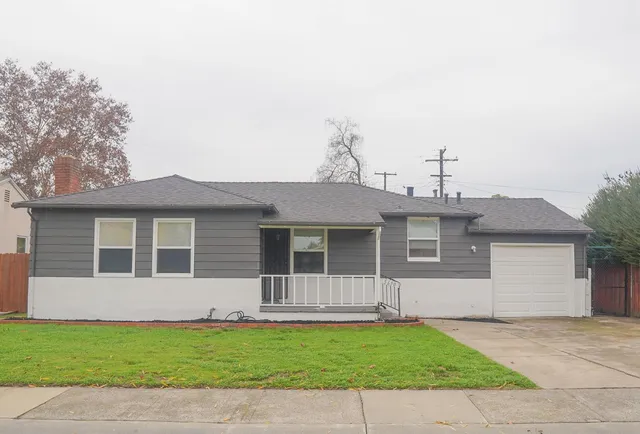 a front view of a house with a garden