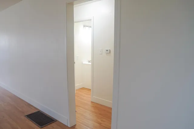a view of a bathroom with wooden floor