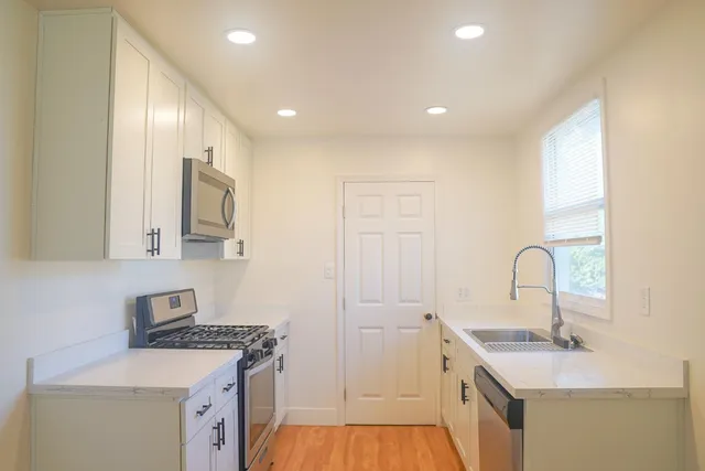 a kitchen with a sink stove and cabinets