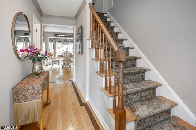a dining room with furniture a chandelier and wooden floor