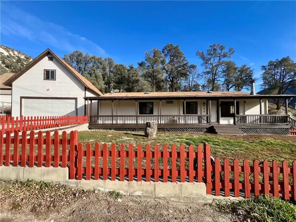 a view of a house with wooden fence