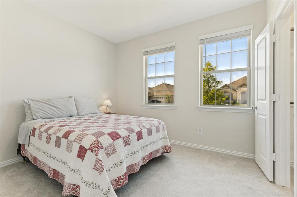 1237 Almond Road Azle, TX 76020 - Photo 19 of 24 a bedroom with a bed and two windows