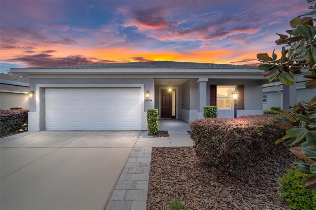 10064 Southwest 88th Street Ocala, FL 34481 - Photo 1 of 47 a view of a house with a yard and potted plants