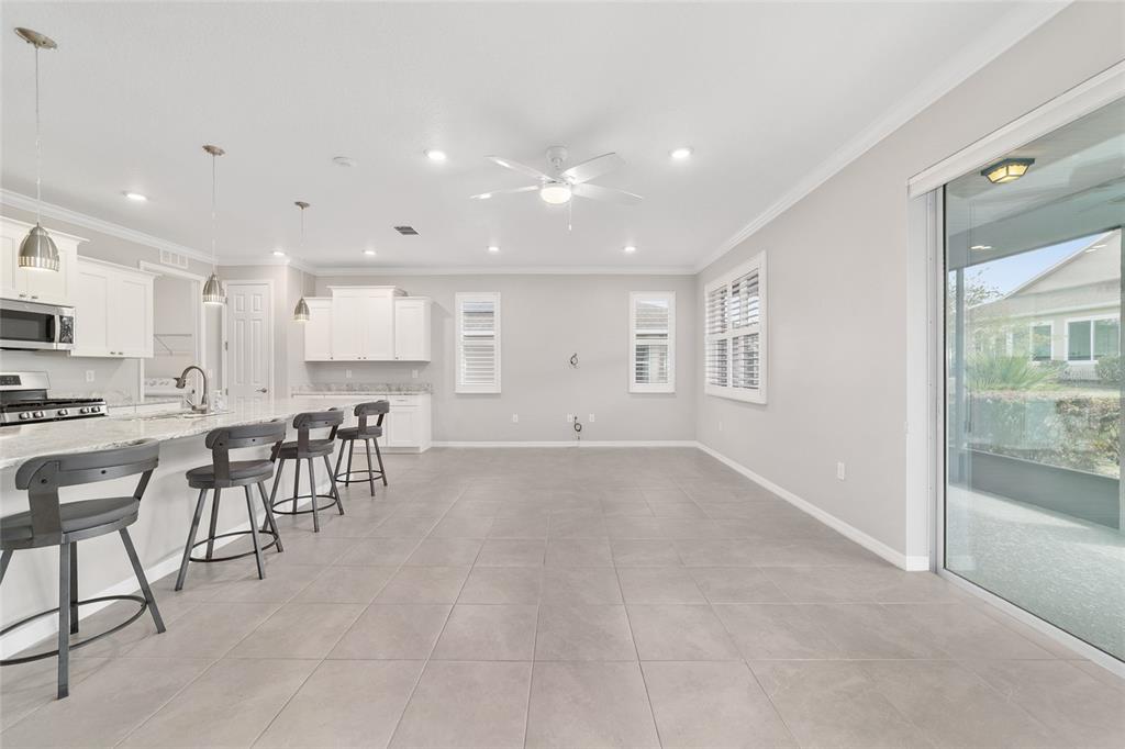 10064 Southwest 88th Street Ocala, FL 34481 - Photo 11 of 47 a view of a kitchen with a dining table chairs and entryway