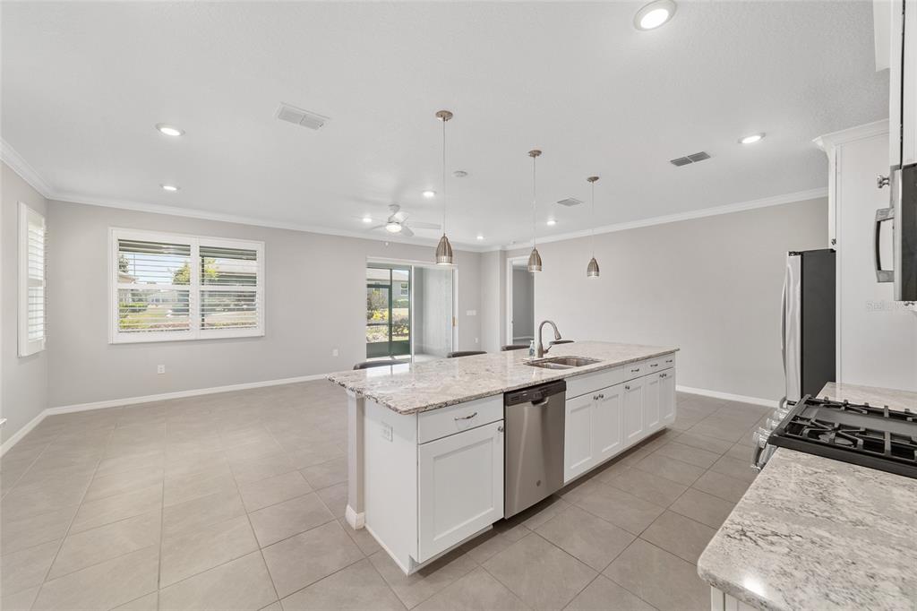 10064 Southwest 88th Street Ocala, FL 34481 - Photo 20 of 47 a kitchen with stainless steel appliances granite countertop a stove and a sink