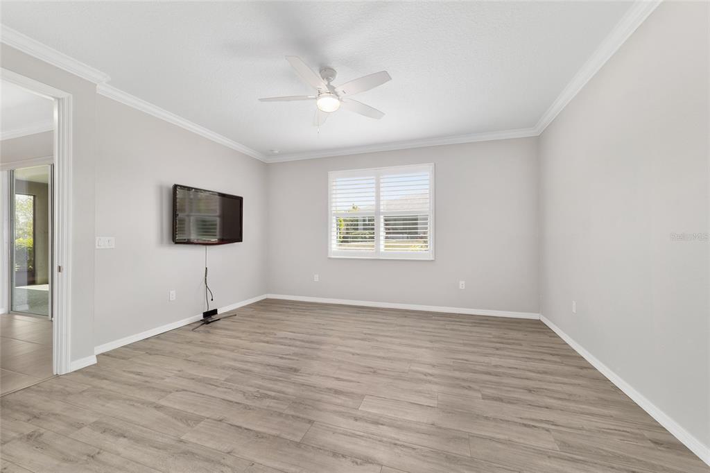 10064 Southwest 88th Street Ocala, FL 34481 - Photo 23 of 47 a view of an empty room with wooden floor and a window