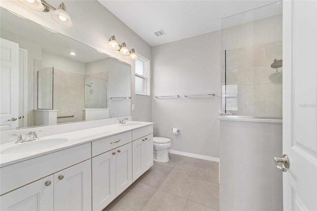10064 Southwest 88th Street Ocala, FL 34481 - Photo 24 of 47 a spacious bathroom with a double vanity sink mirror and double