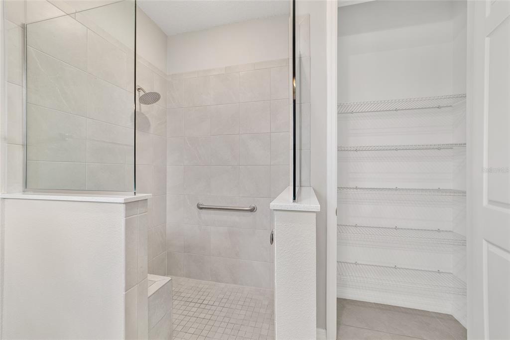 10064 Southwest 88th Street Ocala, FL 34481 - Photo 25 of 47 a bathroom with a glass shower door