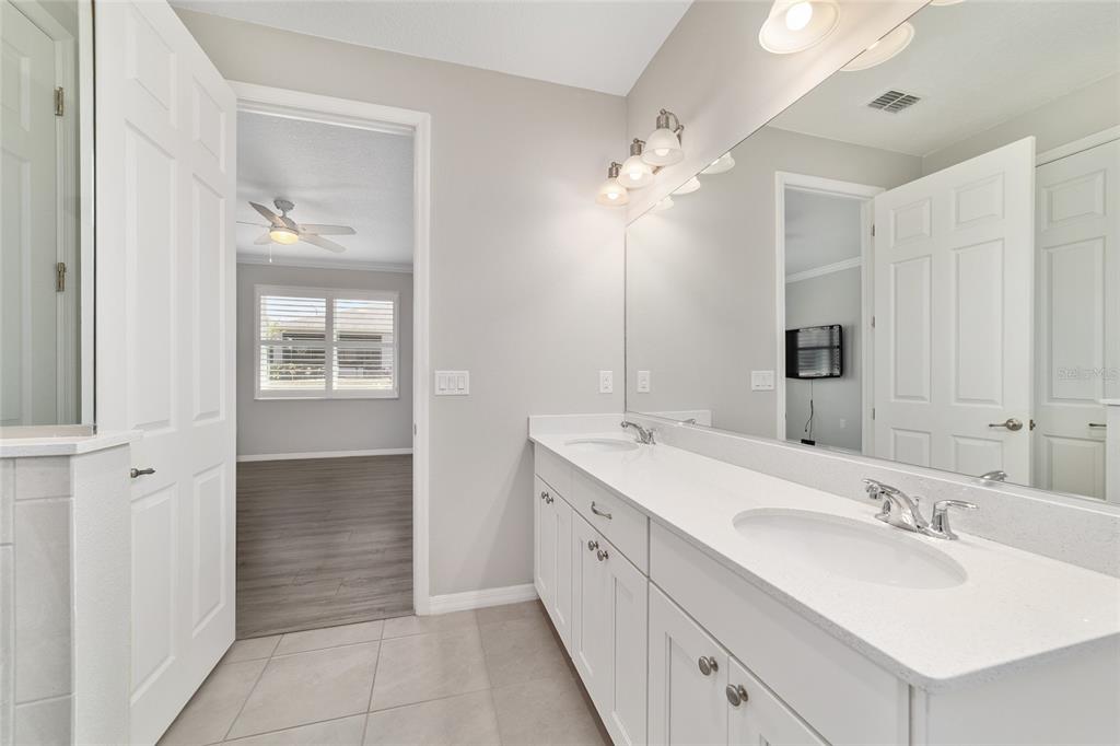 10064 Southwest 88th Street Ocala, FL 34481 - Photo 26 of 47 a bathroom with a double vanity sink a mirror and a