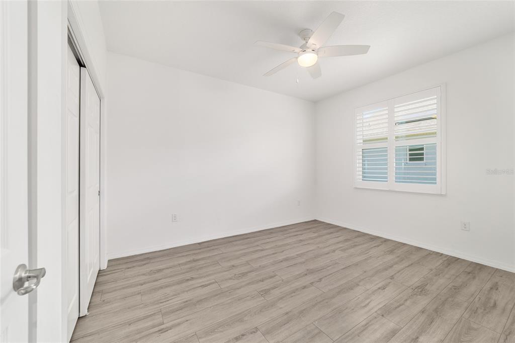 10064 Southwest 88th Street Ocala, FL 34481 - Photo 29 of 47 wooden floor in an empty room with a window