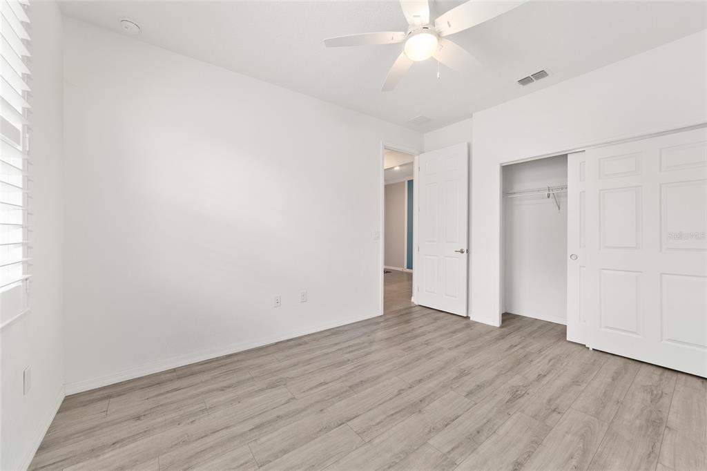 10064 Southwest 88th Street Ocala, FL 34481 - Photo 30 of 47 an empty room with wooden floor and windows